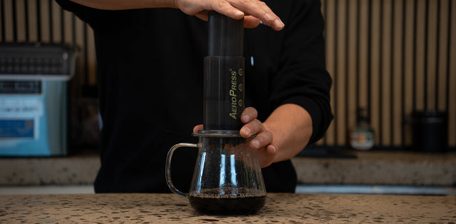 AeroPress pressing coffee into a mug