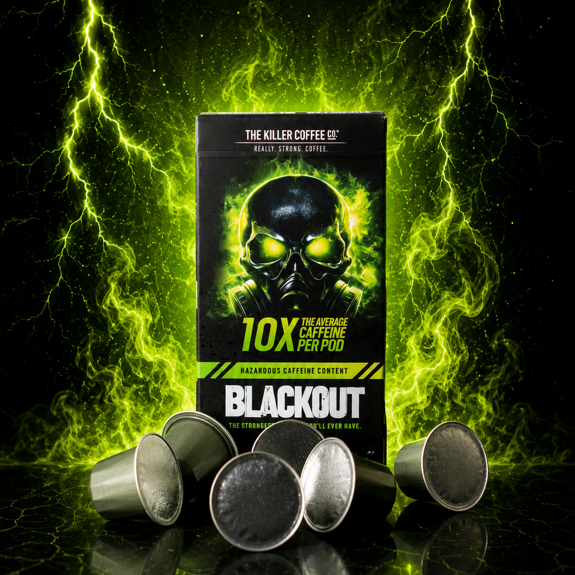 A box of Blackout 10X Caffeine Free Coffee pods stands upright on a glossy black surface, surrounded by several silver coffee capsule pods. The background is a dramatic dark scene with bright green lightning effects.